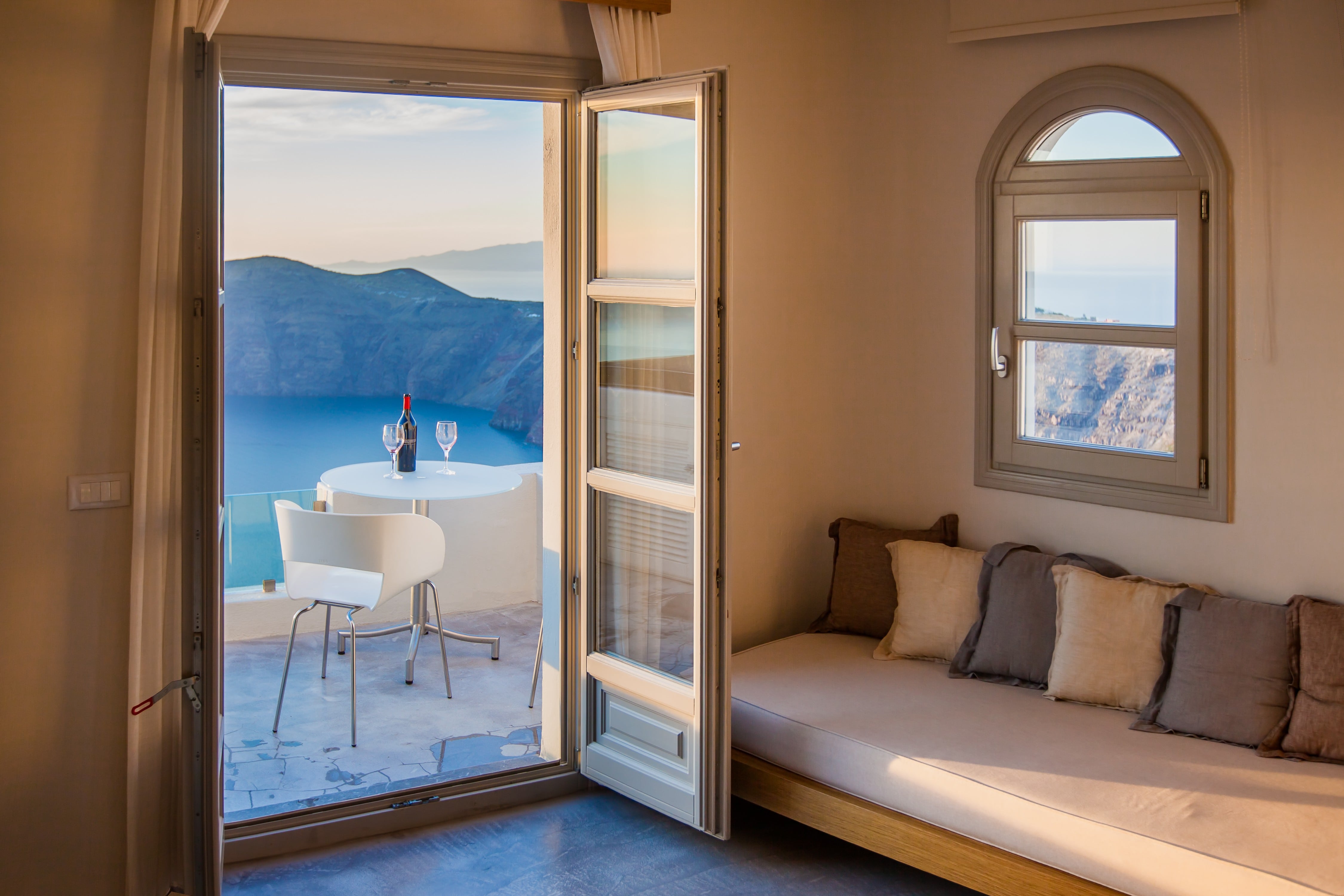 Hotel Room with a terrace that has a table and chair overlooking the Mediterranean