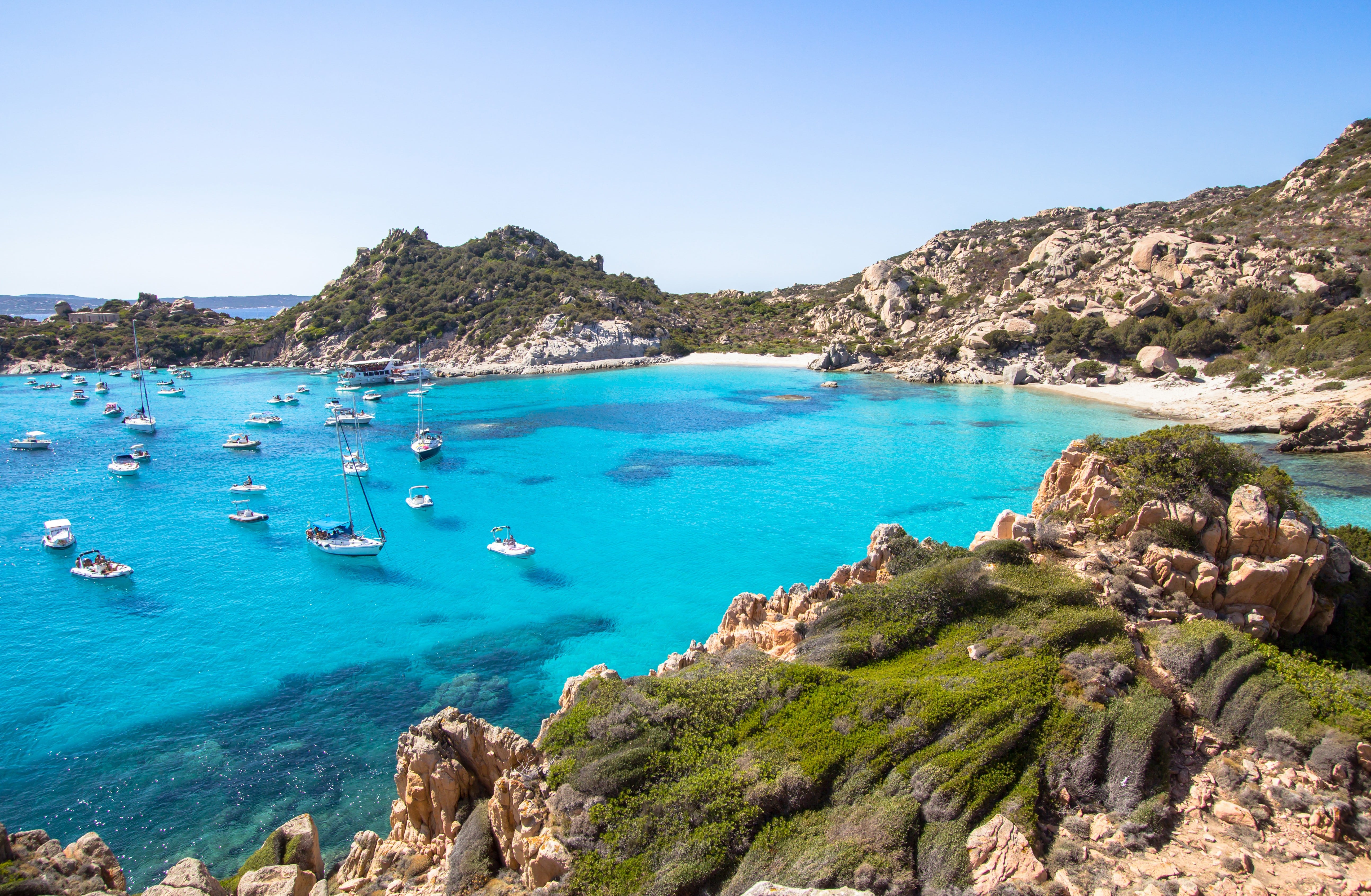 Beautiful beach with anchored sailboats